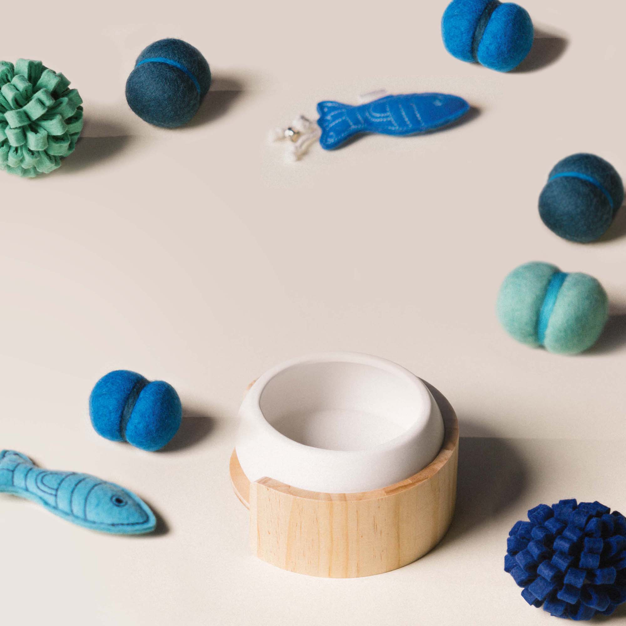 cat toys next to a bowl